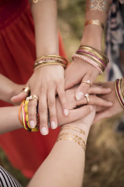 Female hands with accessories holding together