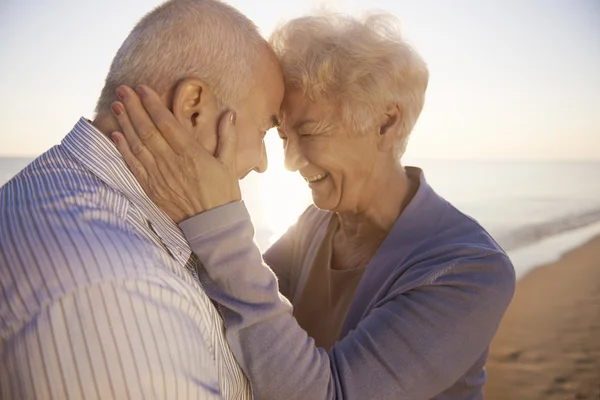 Senior couple hugging  on the beach