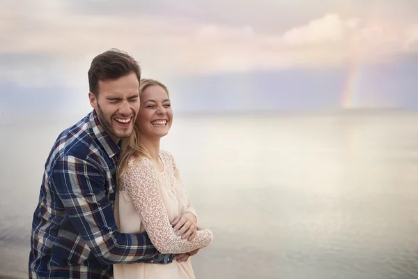 Couple in love having fun by the sea