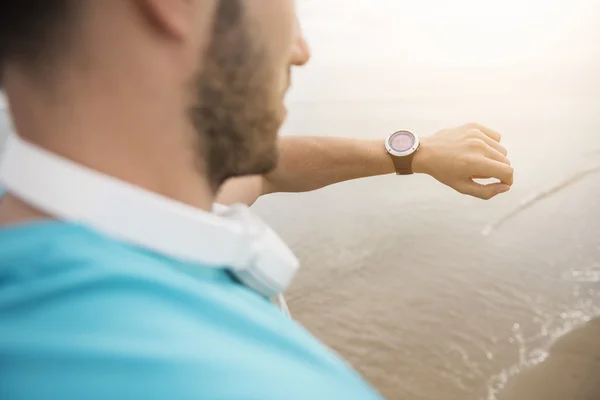 Man looking at sports watch