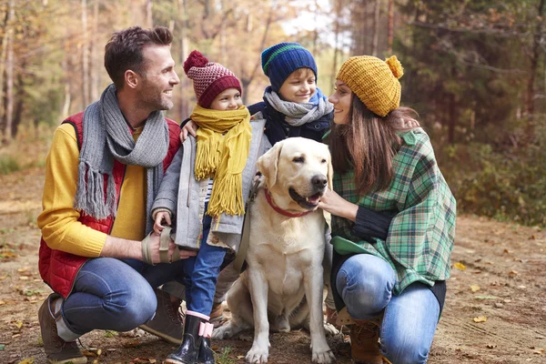 Happy family with dog in the forest