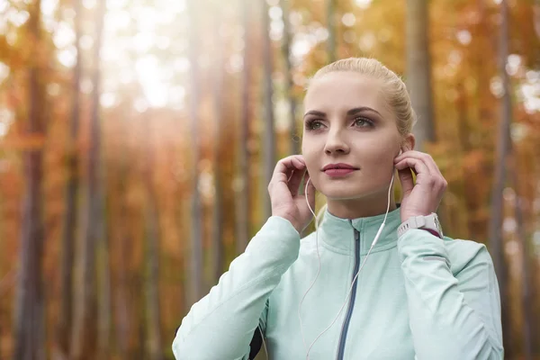 Woman listening to music during jogging