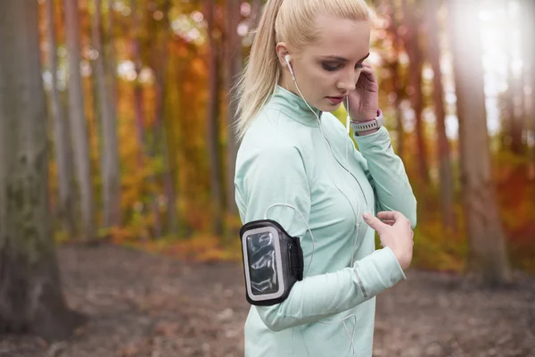 Woman using gadgets during run.