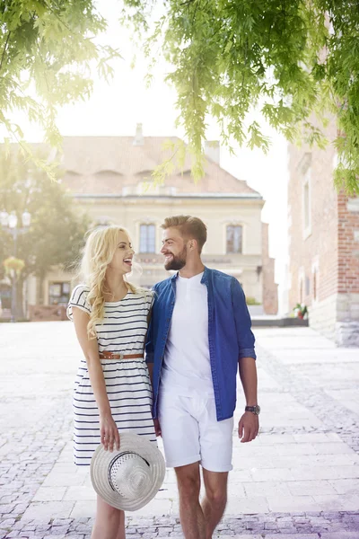 Couple walking in city in sunny day