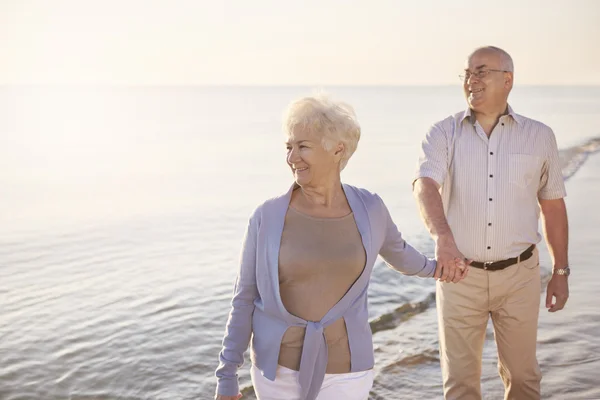 Senior man walking behind his wife