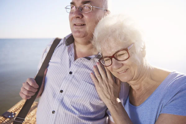 Seniors hugging while going on picnic