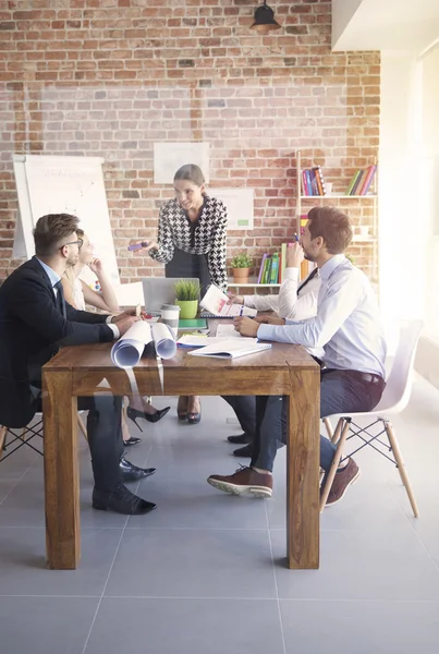 Business people gathering behind glass wall