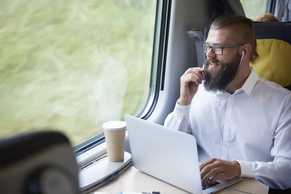 Businessman using laptop computer in train
