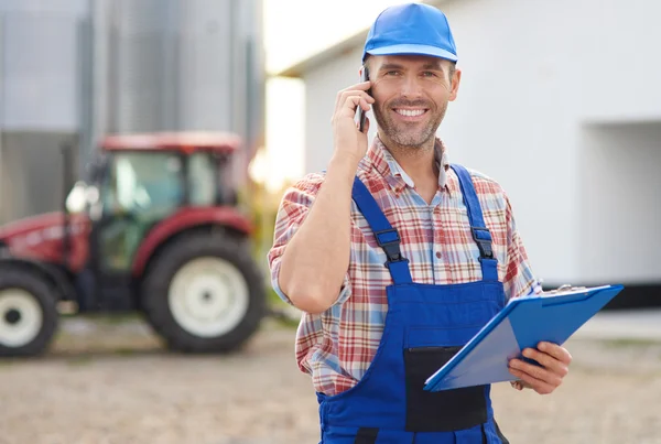 Busy farmer talking on mobile phone