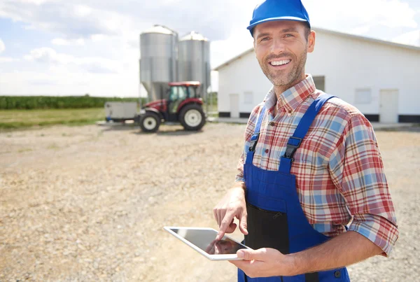 Modern farmer using digital tablet