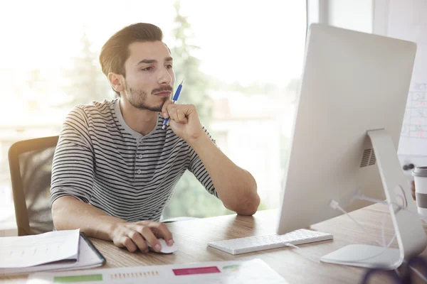 Pensive man in front of computer