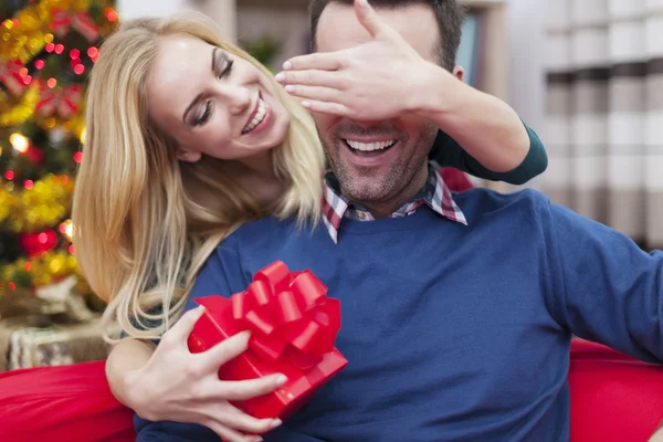 Woman giving gift to her man