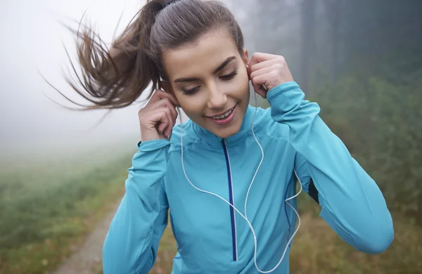 Woman listeting to music while running