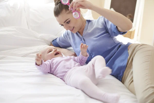 Young mother playing with baby