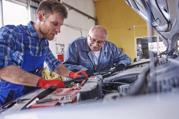 Mechanics in car workshop