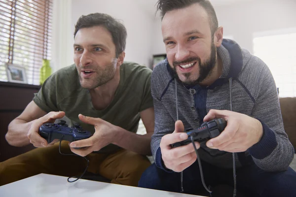 Men playing computer game together