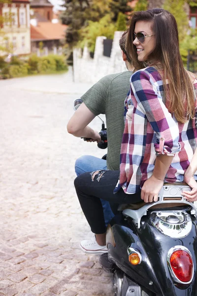 Young couple riding bike in city