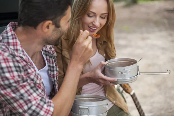 Couple eating camping food