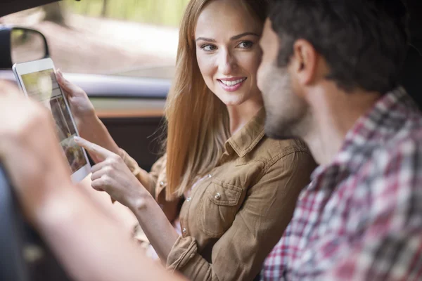 Couple using a Touch Pad in the car