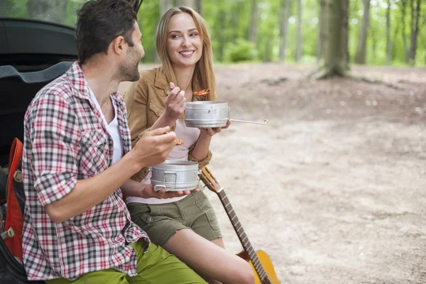Couple eating camping food