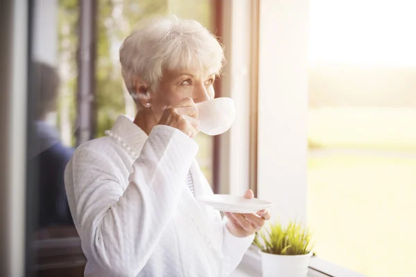 Mature woman drinking coffee