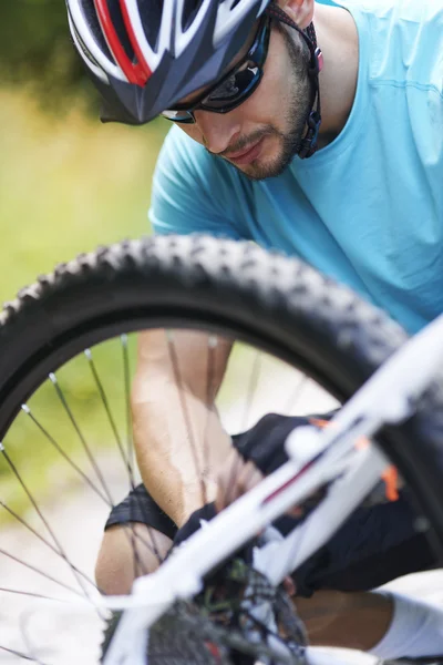 Man checks the bicycle tire