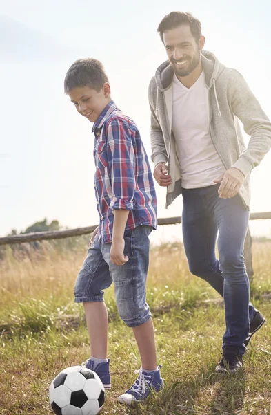 Father playing football with son