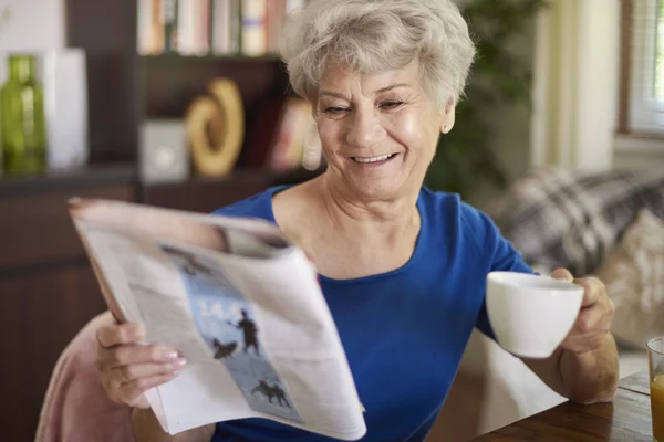 Senior woman reading newspaper