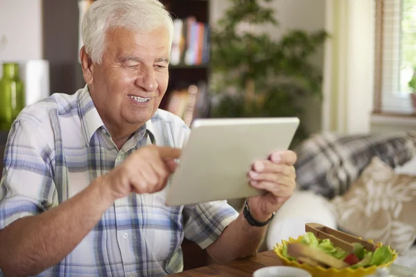 Elder man using a digital tablet