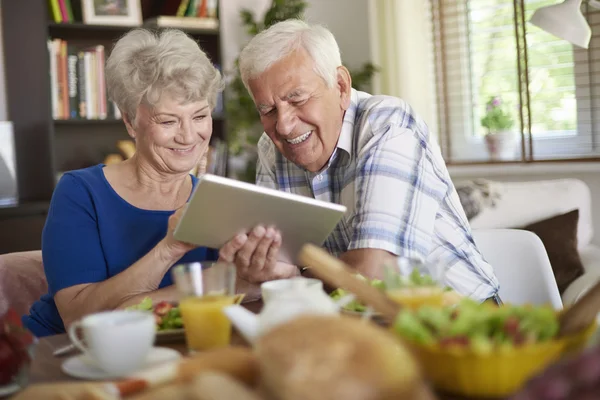 Happy mature couple with tablet