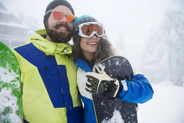 Happy couple with snowboards