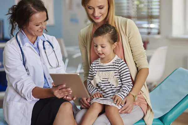 Mother and daughter visit a doctor