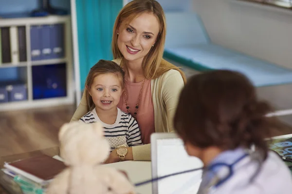 Mother and daughter visit a doctor