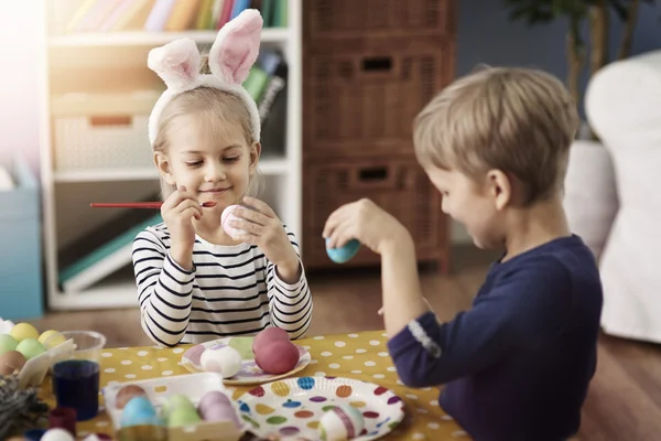 Children painting Easter eggs