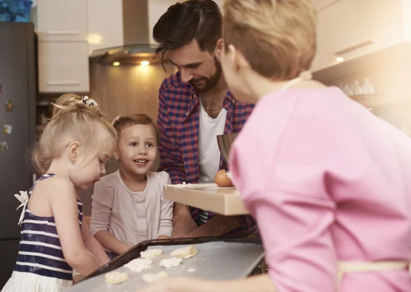 Family baking cookies in kitchen