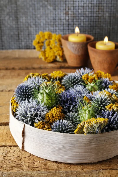Autumn decoration made of wild plants in round box