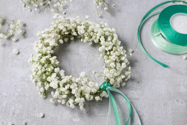 Florist at work. How to make gypsophila paniculata wedding wreat