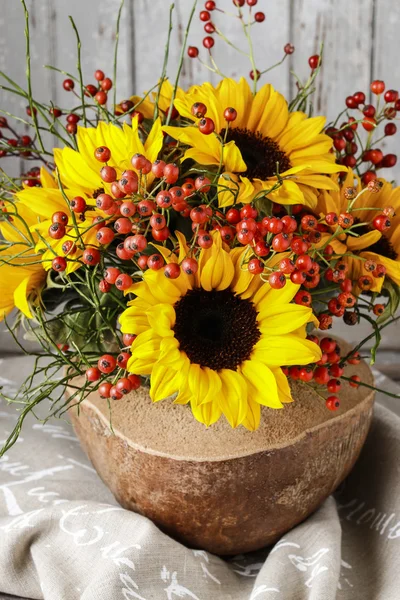 Florist at work: how to make floral arrangement with sunflowers