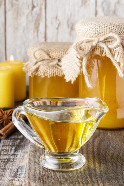 Jars and glass jug of honey