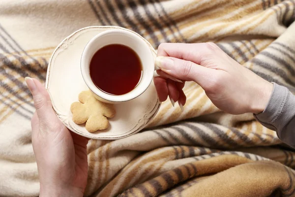 Woman holding a cup of tea