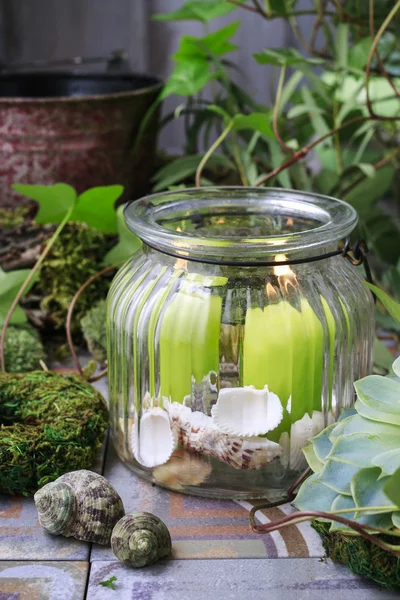 Candles in big glass jar.