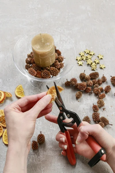 How to make candle holder decorated with cones and dried fruits.