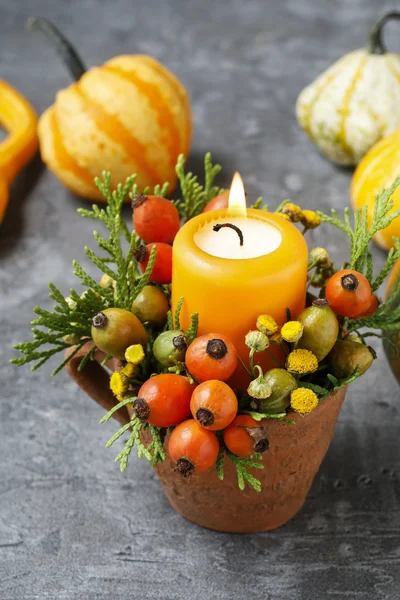 Beautiful decoration with candle and autumn plants