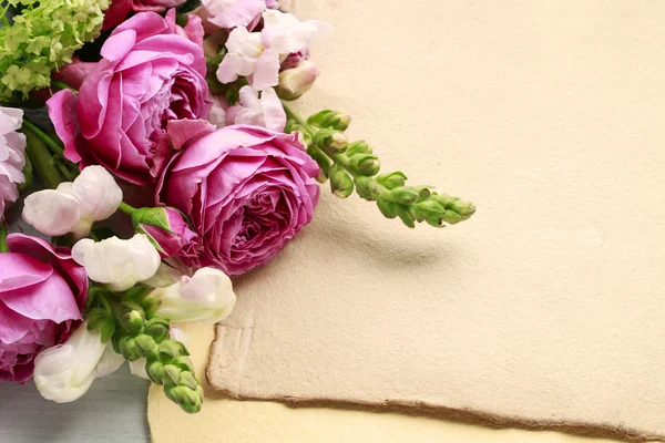 Vintage sheets of paper and bouquet of flowers, copy space