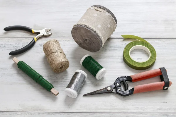 Florist\'s tools on wooden table.