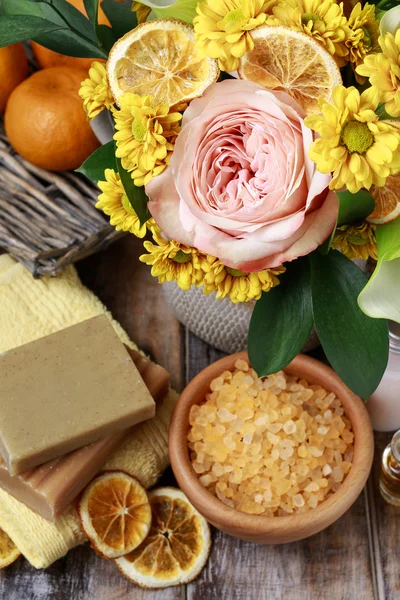 Bouquet of flowers and spa cosmetics: sea salt, bars of soap, to