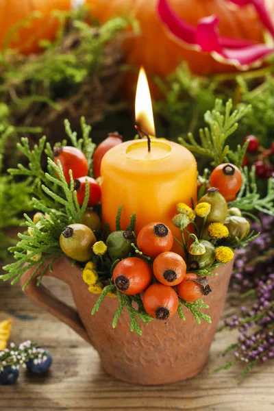 Beautiful decoration with candle and autumn plants