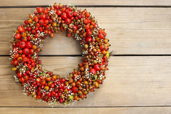 Florist at work: rose hip and hawthorn door wreath