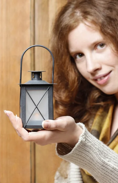 Woman holding christmas lantern.