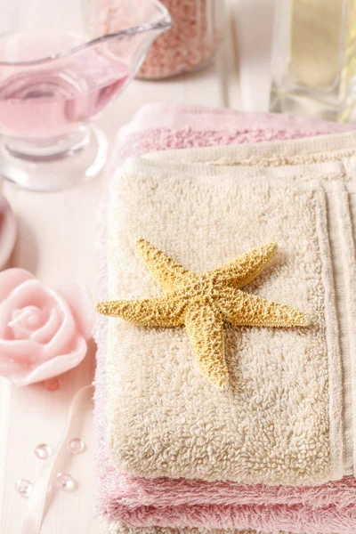 Pink spa set: liquid soap, essential oils, towels and sea salts